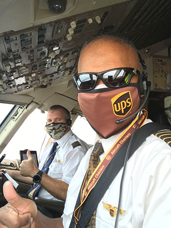 Houston Mills (front) ’85, and Vice President of Flight Operations for UPS, with co-pilot Neal Newell.