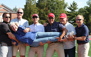 Navarro family members present at the Little Giant Stadium/Frank Navarro Field dedication in September 2021 included (l to r) sons Ken, Jack, Ed, Ben, and P.T.; son-in-law Paul Gelinas; and Jill (center).