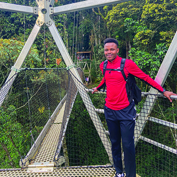 Tuyishime poses at Nyungwe Forest National Park in Rwanda, where he traveled in 2024 as the recipient of a Benjamin A. Gilman International Scholarship. While in Rwanda, Tuyishime studied post-genocide restoration and peacebuilding at the School for International Training, visiting historic sites and meeting with survivors of the 1994 Rwandan Genocide against the Tutsis.