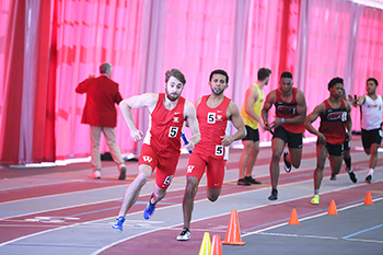 Austin, left, and Parker, middle, run the 4x400 relay.
