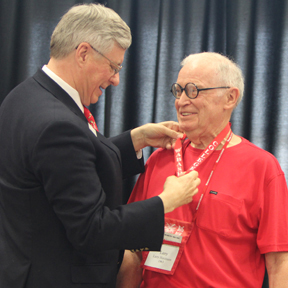 President White presents Larry Hutchison ’63 with his 50th Reunion Medallion.