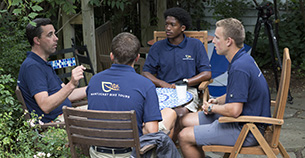 Jason Bridges '98 (left) chats with SaVonne Bennette '19, Joey Lenkey '19, and Cole Crouch '17.