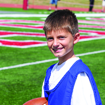 Aidan Walker ’25 as a ball boy at Homecoming 2013. Photo by Corey Egler ’15