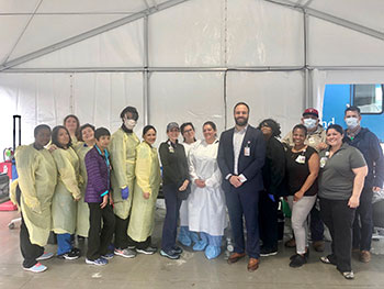 Jared Lange (center) with Parkland Health and Hospital System staff at a COVID-19 drive-thru testing site.