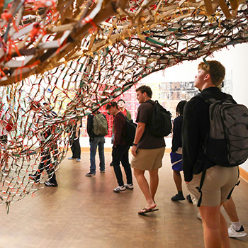 Students from Professor Anne Bost's Enduring Questions class visited the gallery of Artist in Residence Akindiya Akirash and had a chance to interact with the artist.