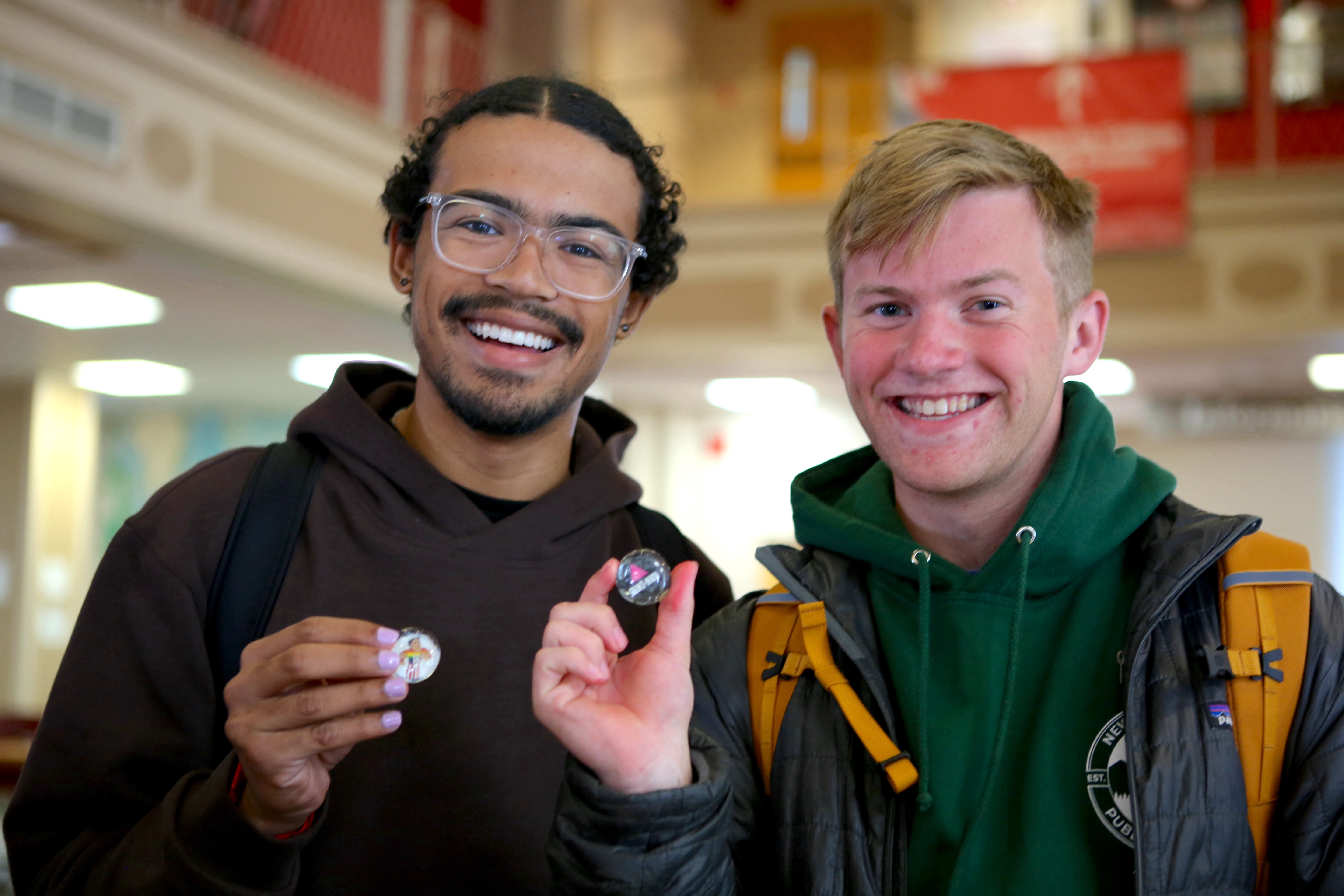 ’shOUT President Luis Rivera ’25 (left) joined his peers in Lilly Library during LGBTQ+ History Month and made buttons that represent inclusion and support for queer cultures.   