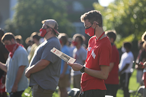 A member of the Class of 2024 reads the school fight song lyrics