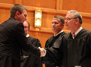 Judge Heimann '77 congratulating Wade