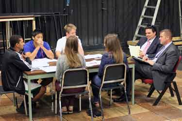 Tim Craft and Scott Benedict, at far right, negotiate with the OLAB students