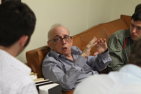 Jaime Suchlicki talks with students in his office at the University of Miami