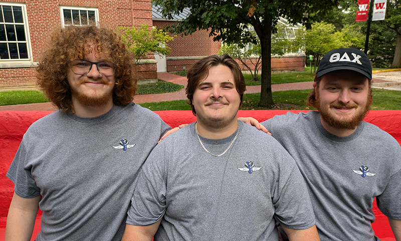 Carson Wintz ’26, Ethan Hill ’26, and Carter Bertsch ’26 sit on the senior bench.