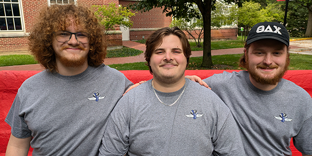 Carson Wirtz ’26, Ethan Hill ’26, and Carter Bertsch ’26 sit on the senior bench.