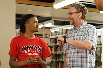 Accessible professors is a strength of the Wabash education. Here Professor of Theater Michael Abbott (left) talks with a student in the Lilly Library.