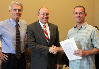 Dean Phillips, President Hess, Wetzel at signing.