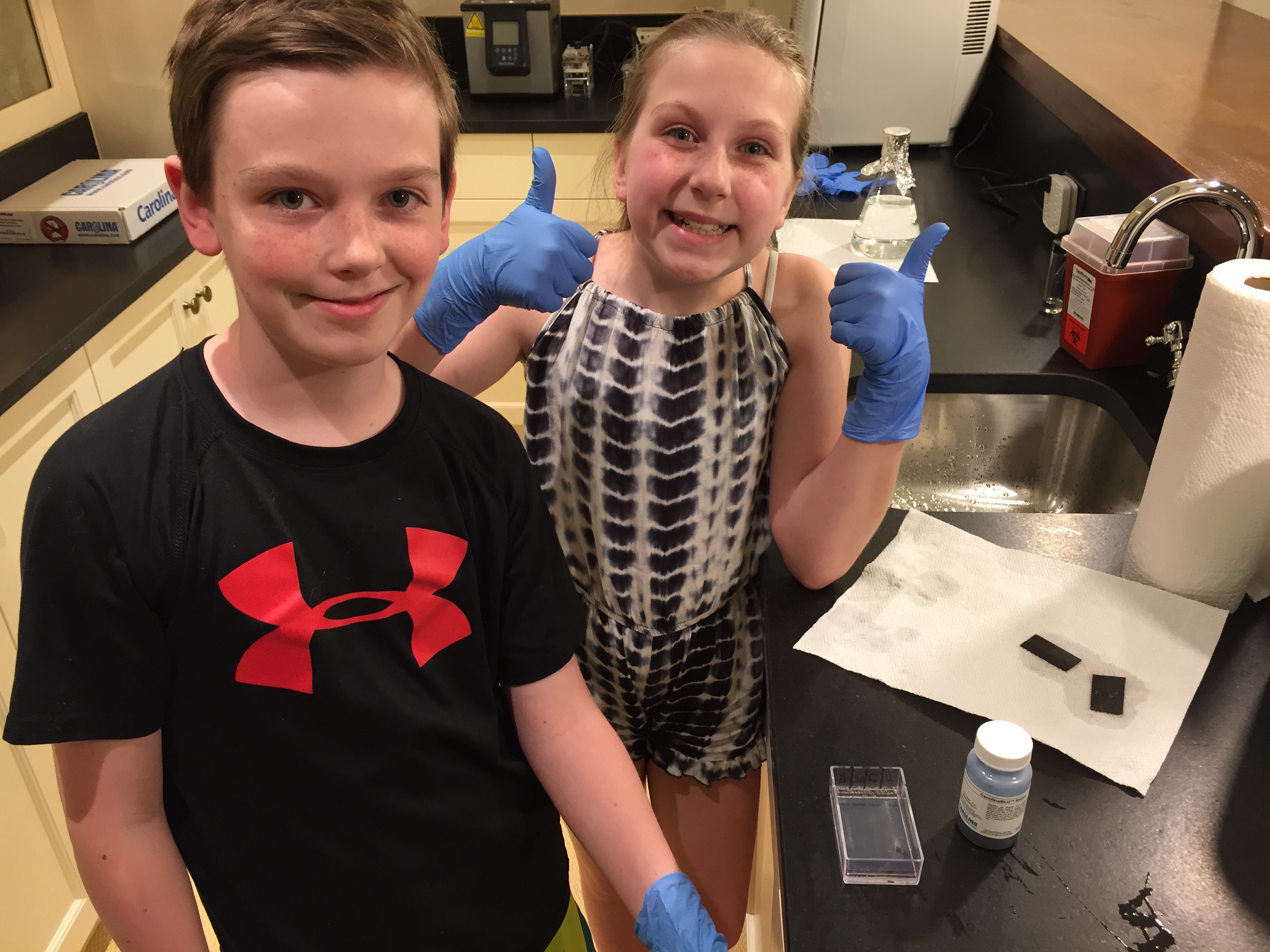 Daniels’ son, Colin, and daughter, Rebecca, proudly show off their work in the family’s molecular biology lab years ago. Colin is now a sophomore at Lawrence University studying computer science. Rebecca is taking a gap year and will start studying documentary film making at Syracuse University.