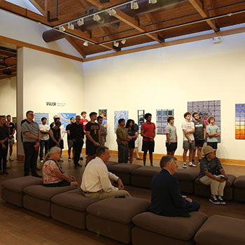 Exhibit attendees listen to the artist talk