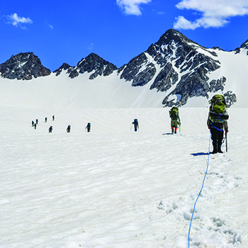 A team on the 40 Days/40 Nights Expedition traveling across Mammoth Glacier in Wind River Range, Wyoming.
