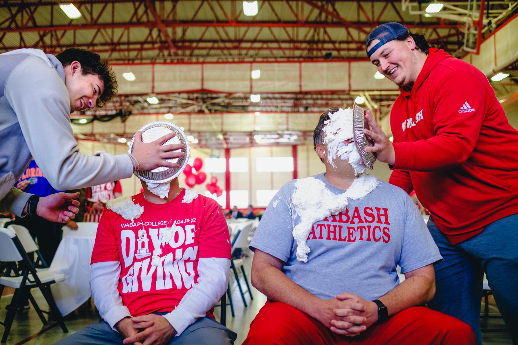 Head Basketball Coach Kyle Brumett (left) and Assistant Football Coach Olmy Olmstead ’04 won the raffle to get a pie in the face to celebrate Day of Giving. 