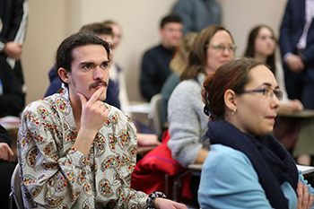 John Kirts '20 listens to one of the oral presentations.