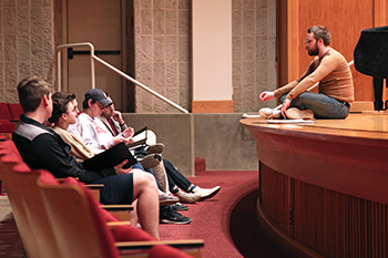 Muha gives direction during rehearsal. 