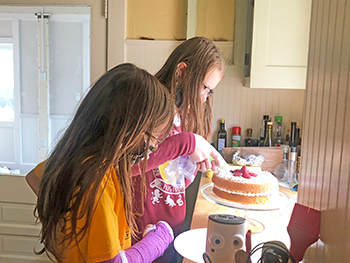 Soren Olofson, left, and Hope Taylor decorate their Victoria Sandwich