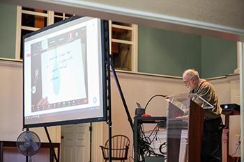 Dr. Blix teaches from the stage of Pioneer Chapel