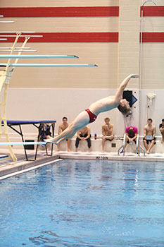 Zach Kintz '20 jumps off the diving board.
