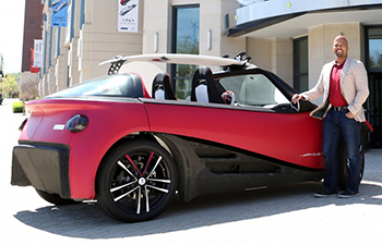 David Woessner with a 3D printed car.