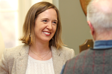 Professor Adriel Trott talks with Professor Joe Day during Monday's reception celebrating the publication of Trott's book, Aristotle on the Nature of Community.