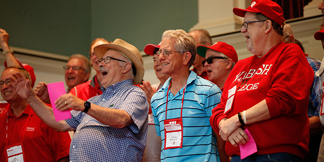 a group of men in red shirts