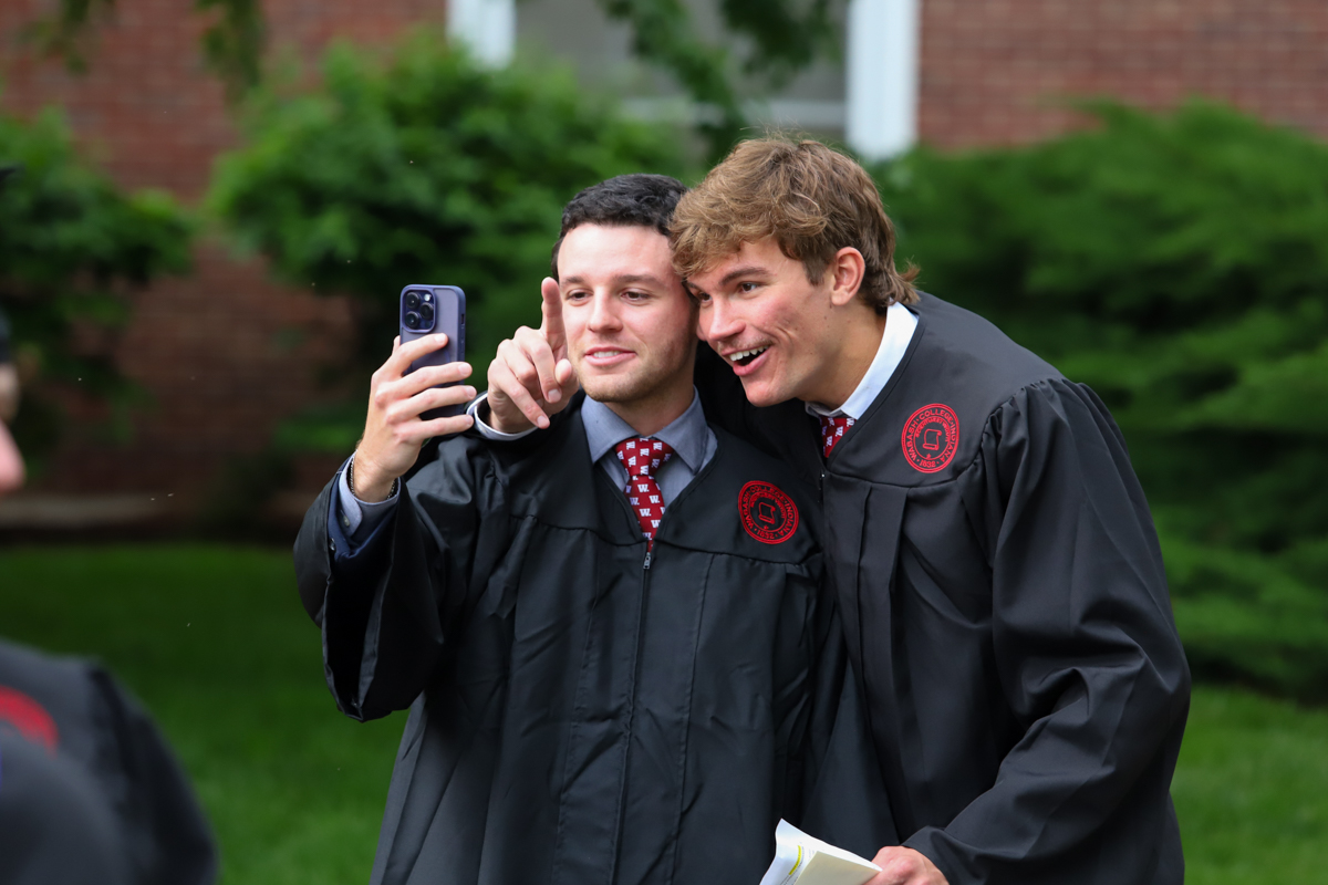 Ghidini (right) snaps a selfie with a classmate prior to Commencement.