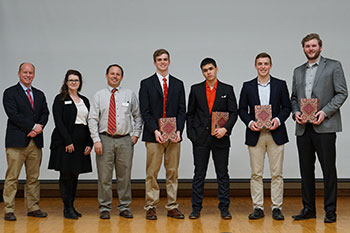 The four contestants pose with event judges