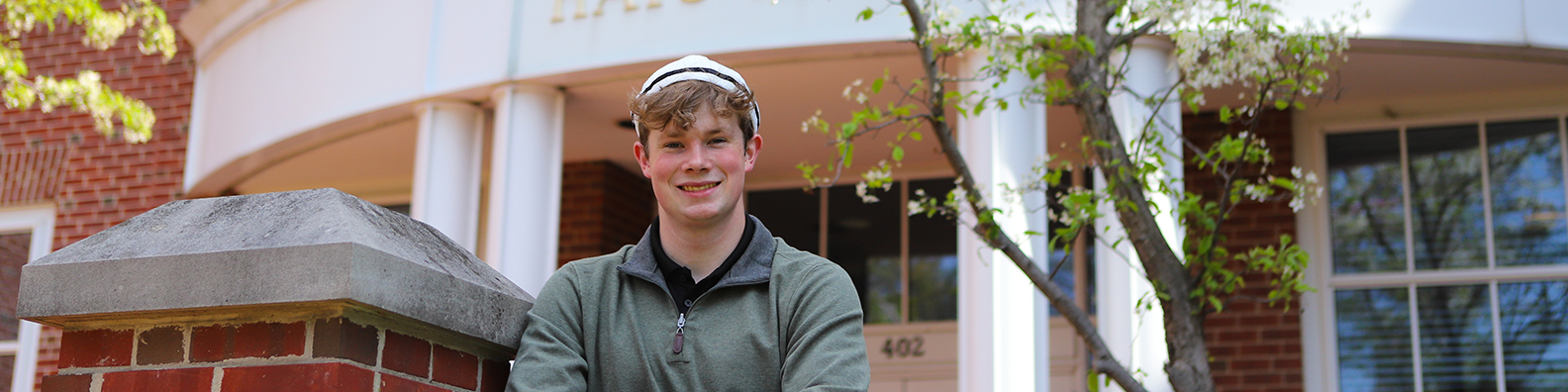 Aidan Mason &rsquo;26 in front of Hays Hall