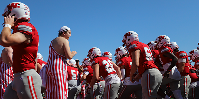 a group of football players in red and white uniforms