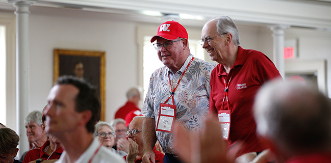 Two alumni approach the stage to sing "Old Wabash."
