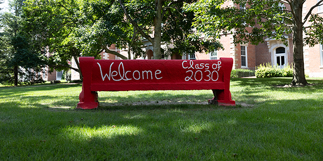 a red bench with white writing on it