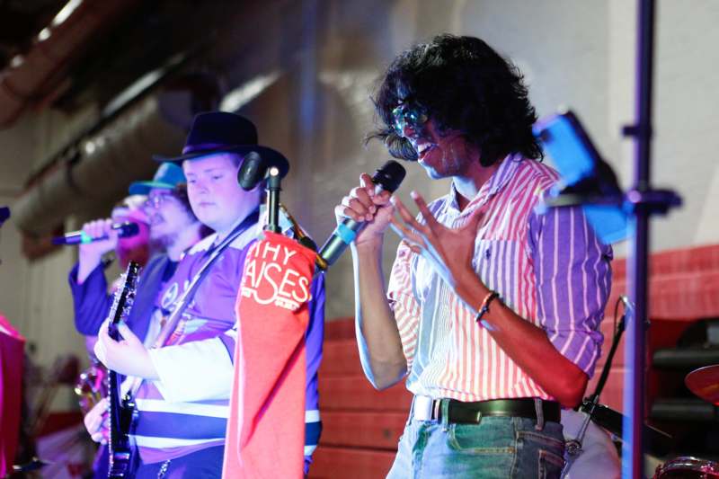 a group of people singing and playing instruments