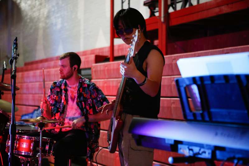 a man playing guitar and a man playing drums