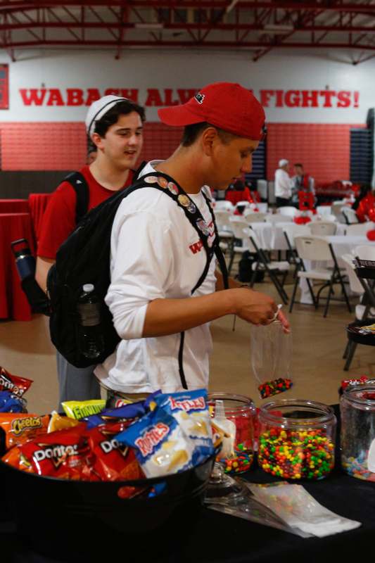 a man putting candy into a plastic bag