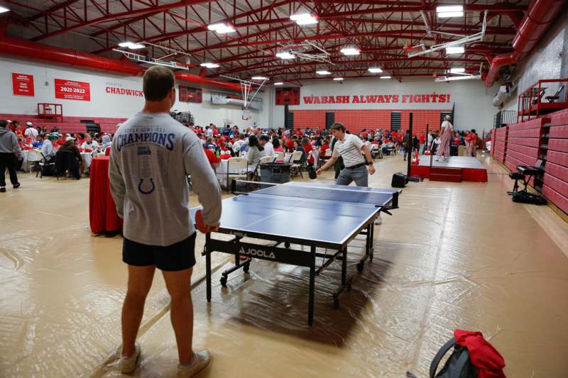 a group of people playing ping pong
