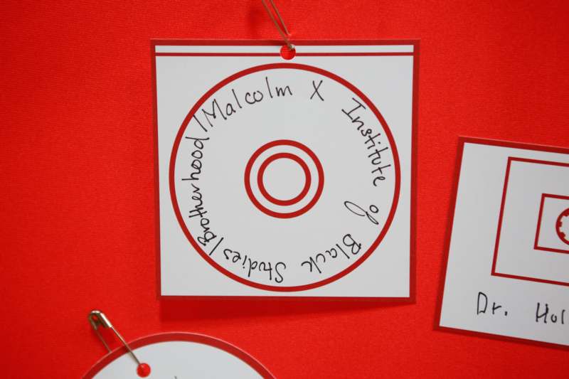a group of white paper tags with red trim