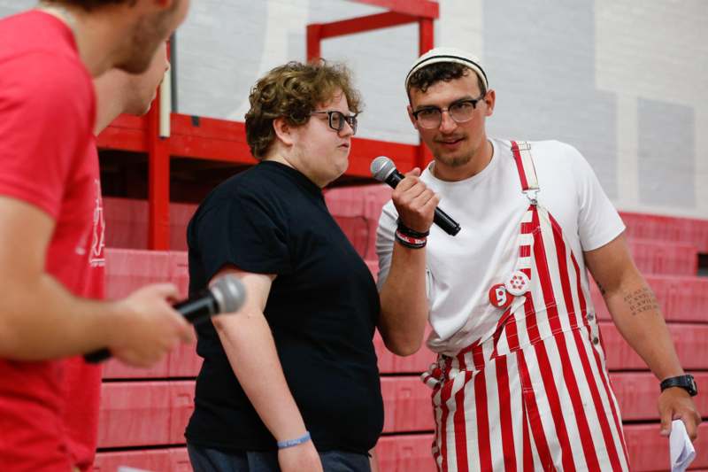 a man holding a microphone and another man standing next to him