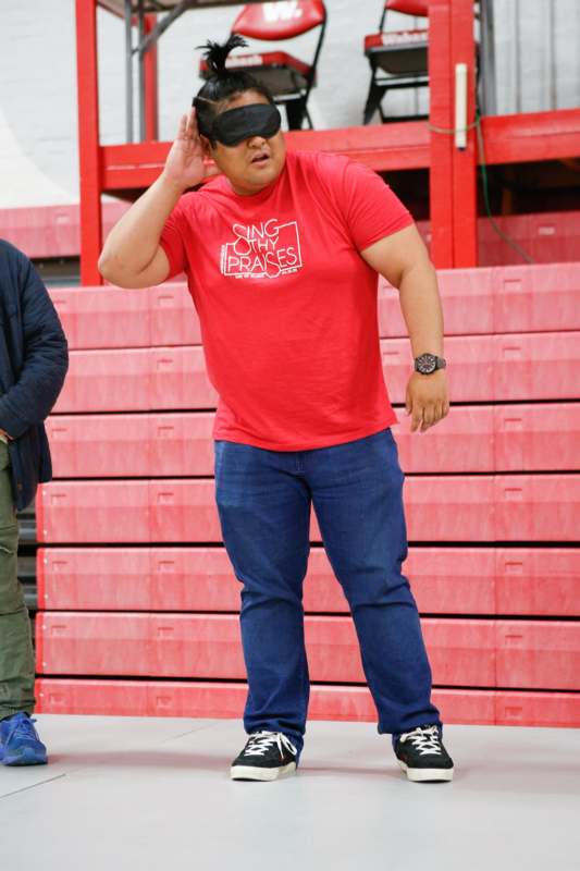 a man wearing sunglasses and a red shirt