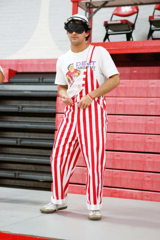 a man in red and white striped overalls