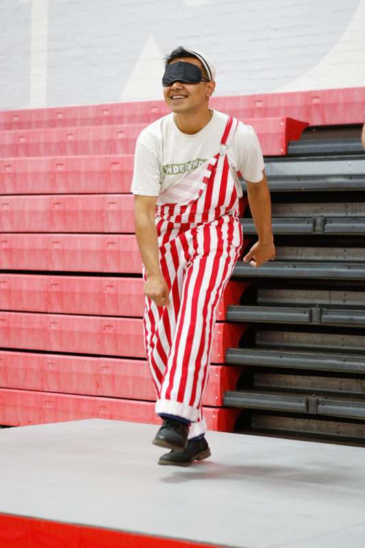 a man in red and white striped overalls