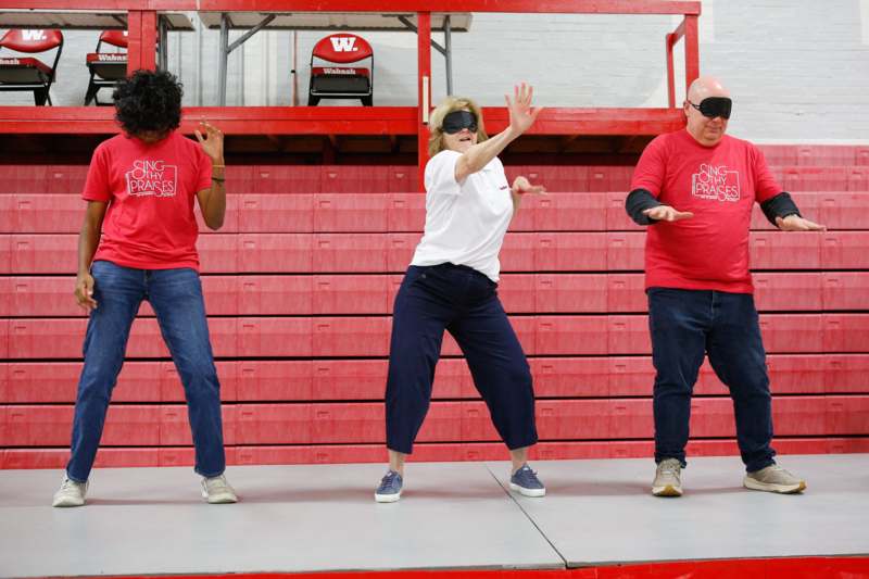 a group of people dancing in a gym