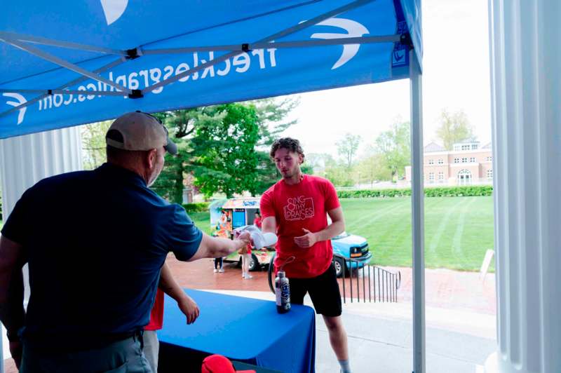 a man shaking hands with a man