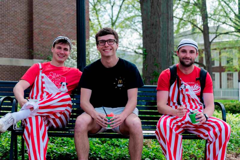 a group of men sitting on a bench