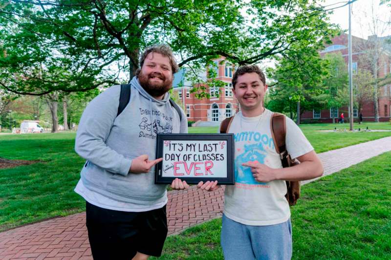 two men holding a sign