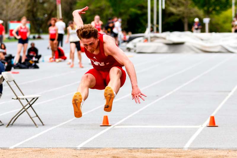 a man jumping over a track